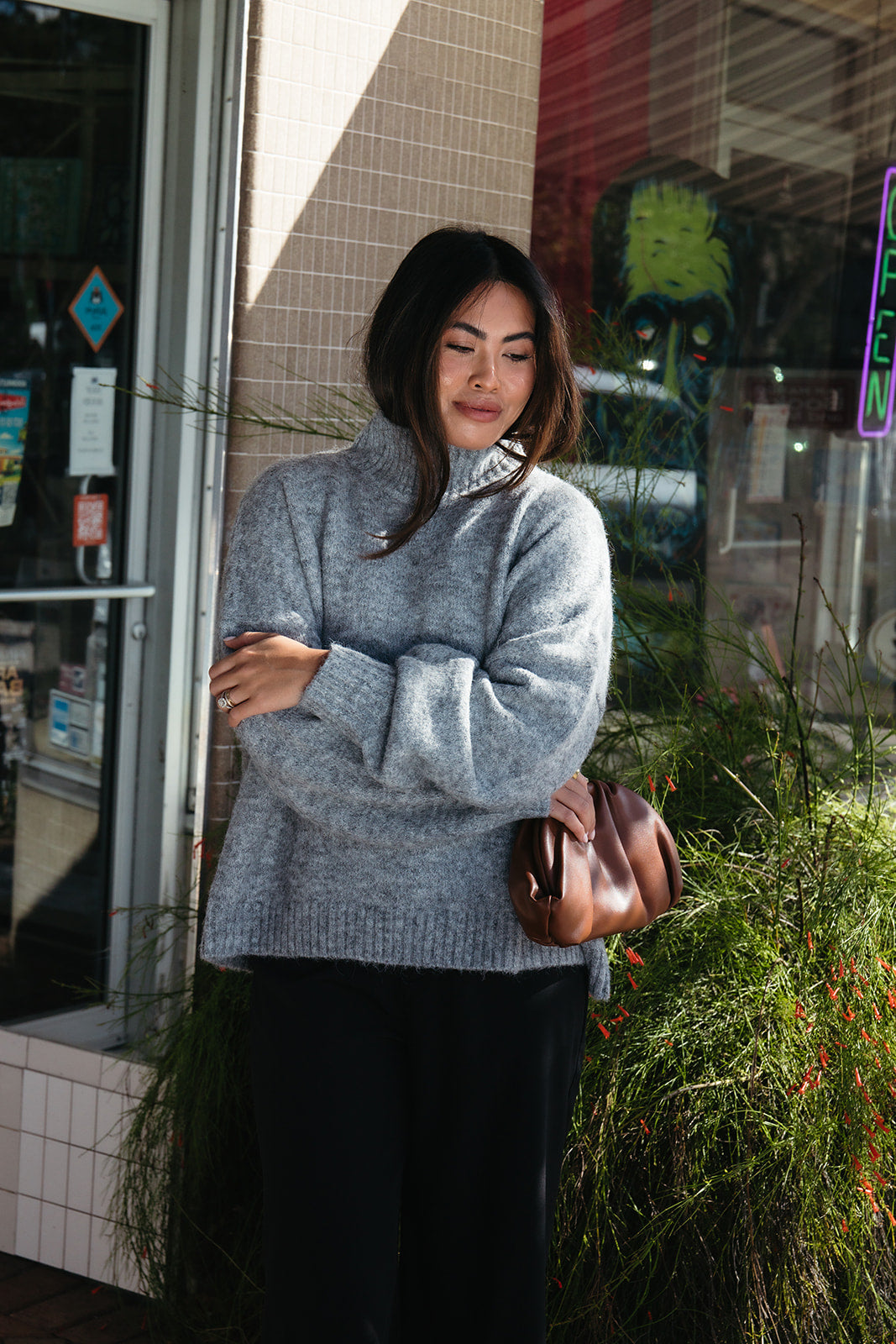 Woman wearing the Audette Sweater, an oversized charcoal heather grey ribbed turtleneck sweater