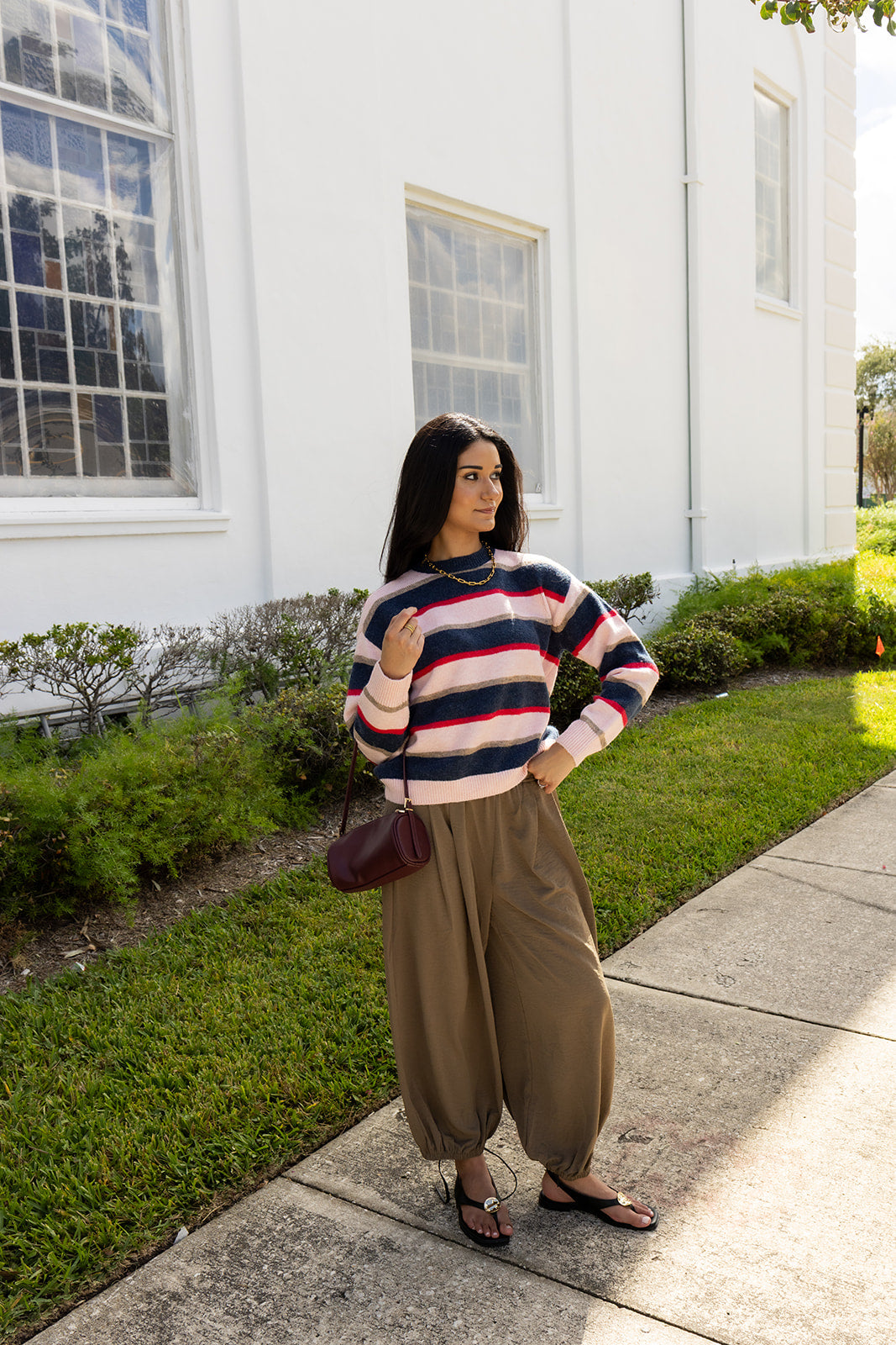 Woman wearing the Carlyle Everyday Sweater, a relaxed navy, cream and blush striped crewneck sweater