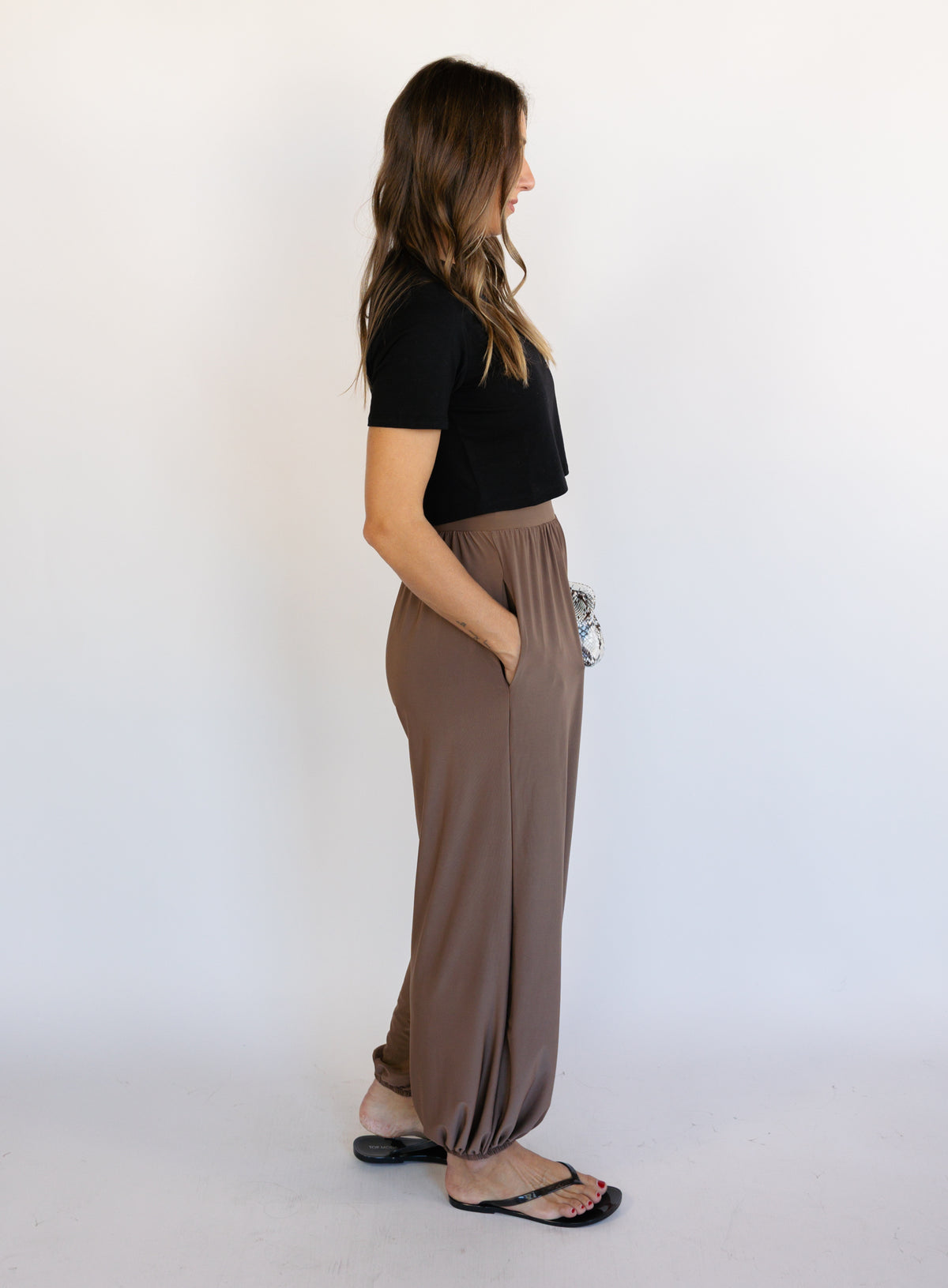 Woman wearing the Rome Relaxed Fit Balloon Pants in Coffee, brown high-rise pull-on balloon pants