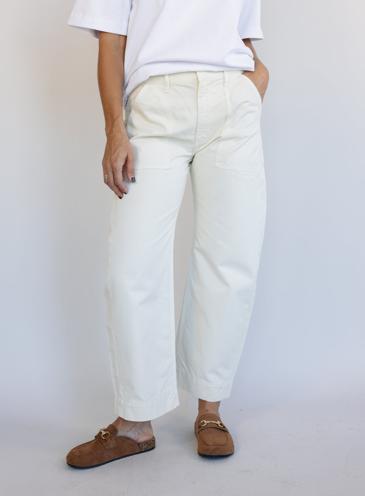 Woman wearing Favorite Daughter The Major Pant, winter white mid-rise barrel-leg cotton pants