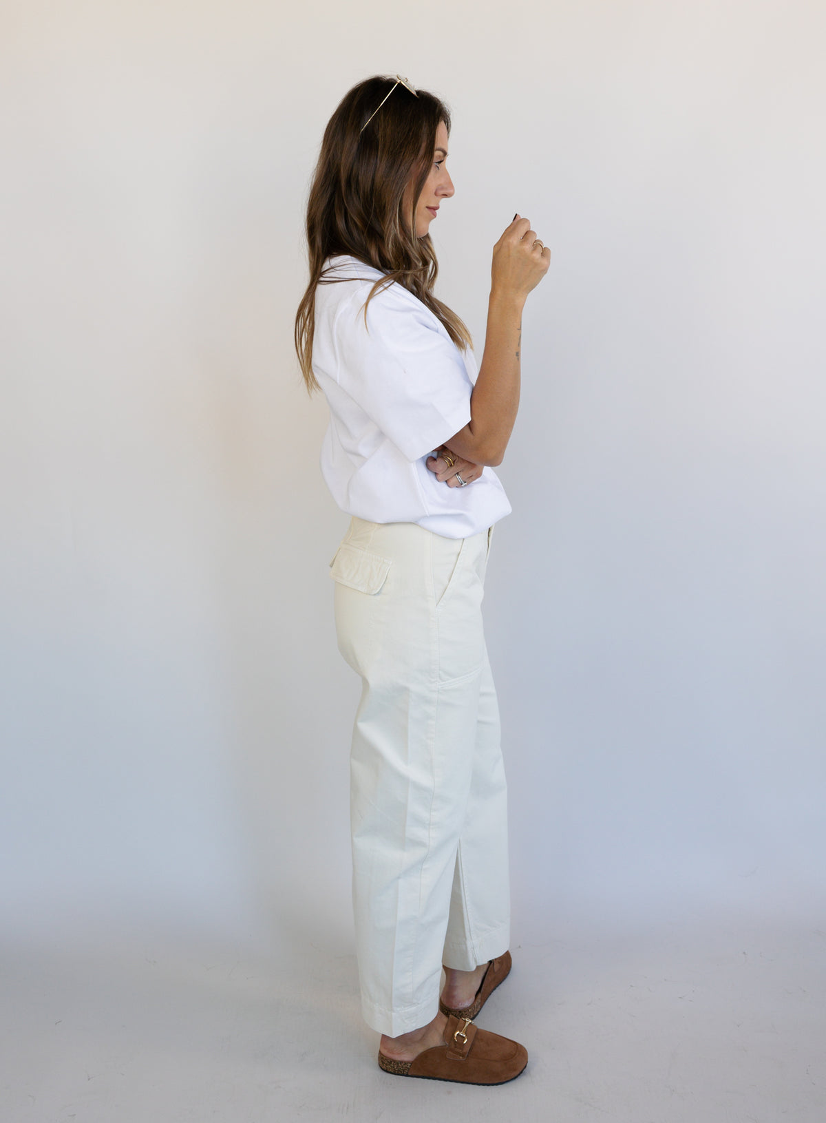 Woman wearing Favorite Daughter The Major Pant, winter white mid-rise barrel-leg cotton pants