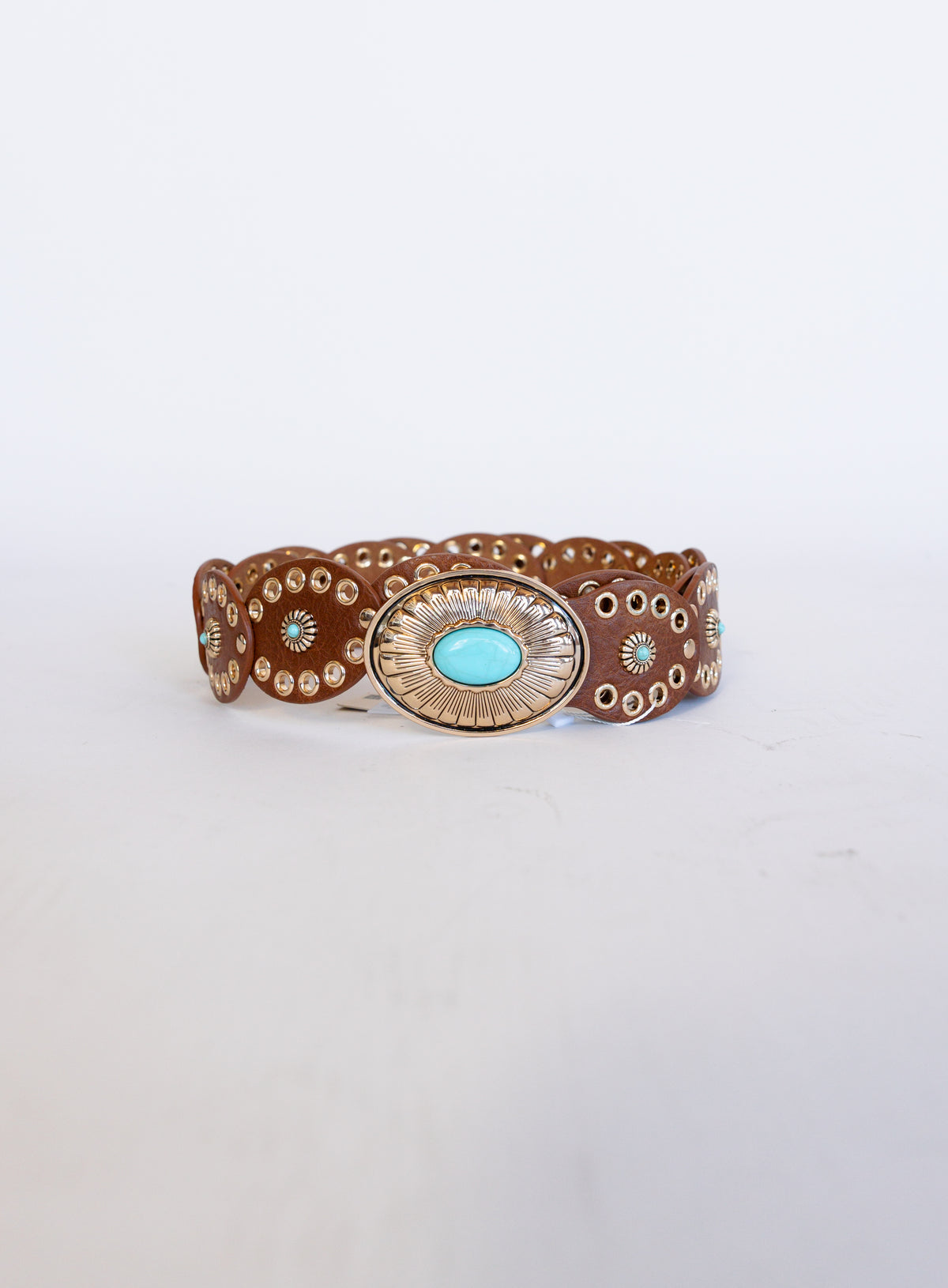 Mirabel Turquoise Disc Belt, a tan disc belt with silver grommets and a turquoise-tone buckle