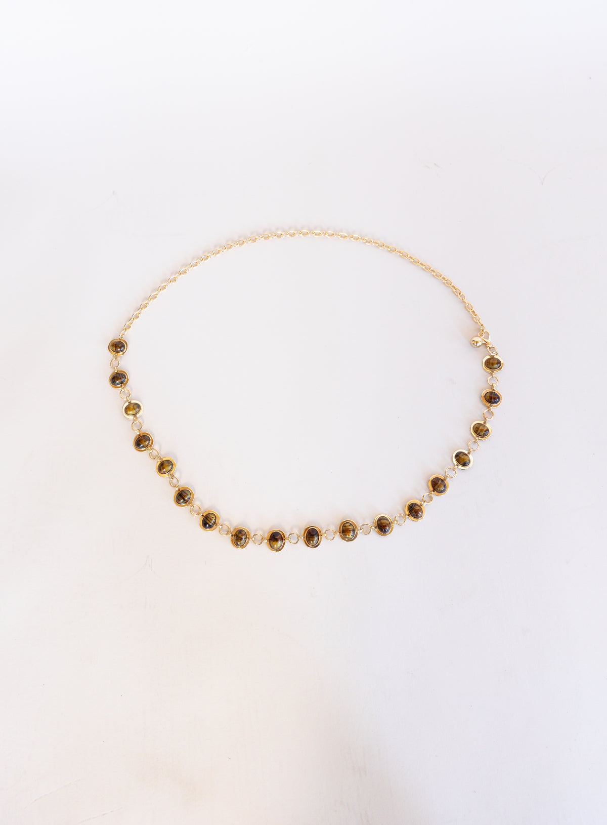 Rosalind Chain Belt, a gold-tone chain belt with glossy tortoise-tone stones
