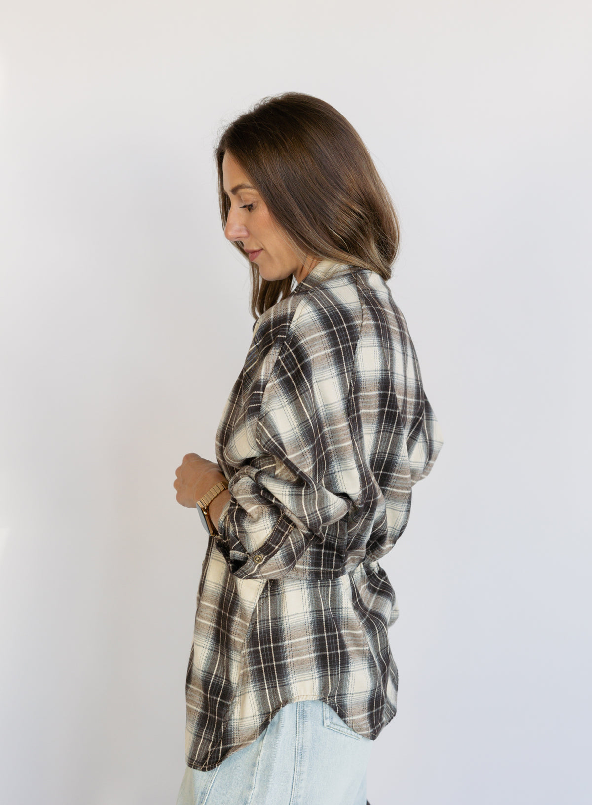 Woman wearing the Heartloom Bobbie Shirt, a black, cream and grey plaid oversized button-down