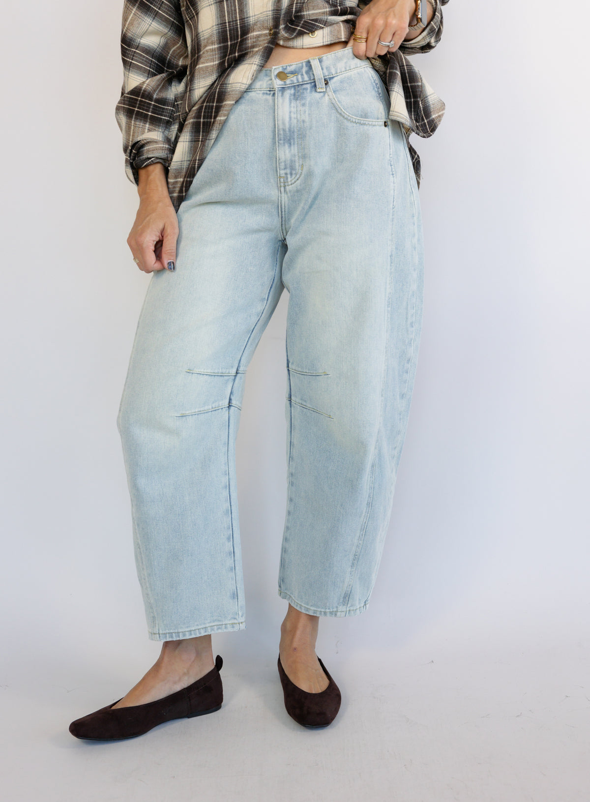 Woman wearing the Poet Barrel Denim Jeans, light-wash high-rise barrel-leg jeans
