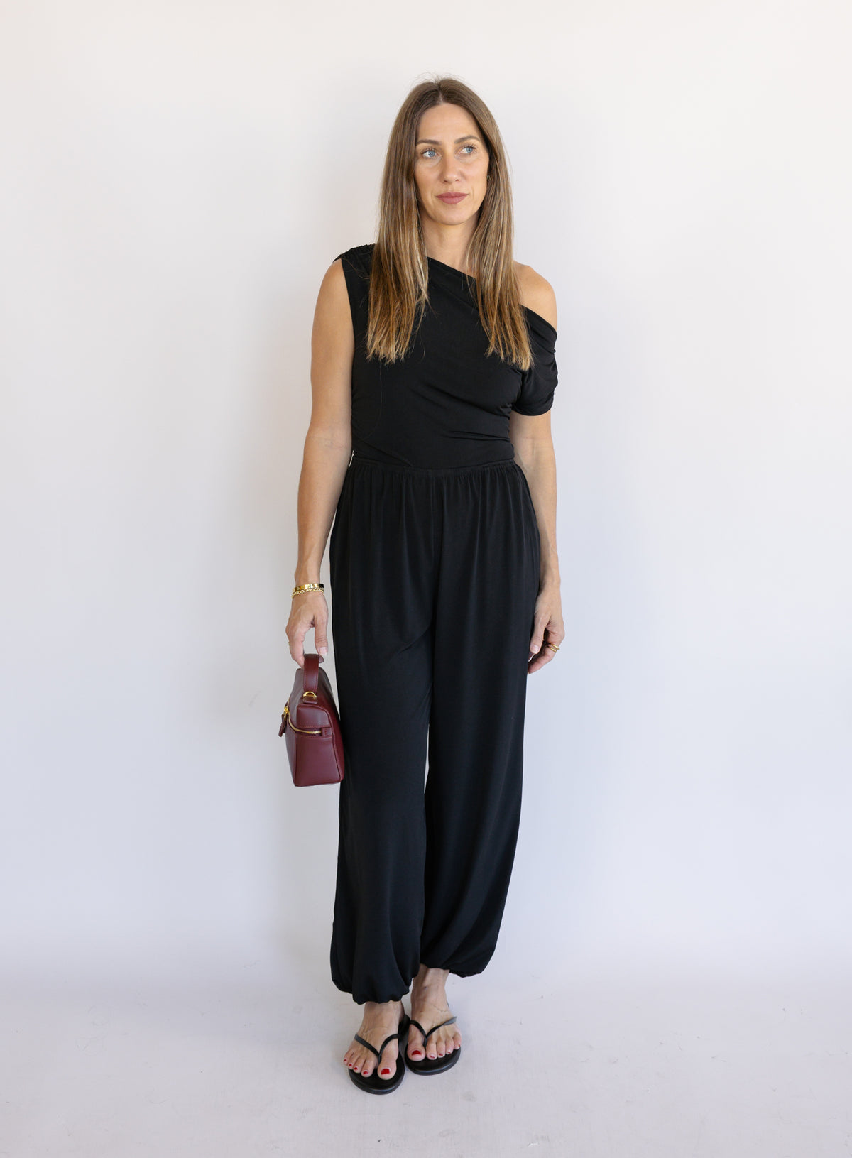Woman wearing the Azalea Balloon Pants, black lightweight balloon-leg pants with gathered ankle cuffs