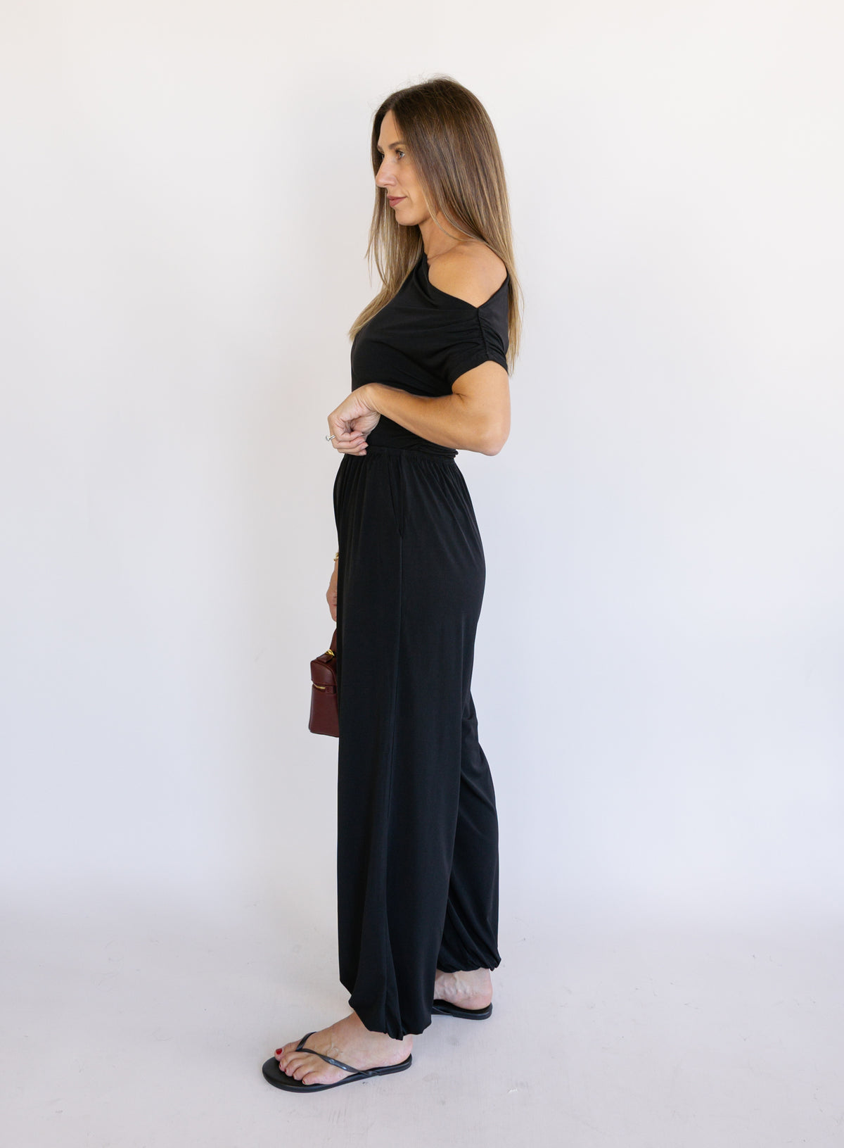 Woman wearing the Azalea Balloon Pants, black lightweight balloon-leg pants with gathered ankle cuffs