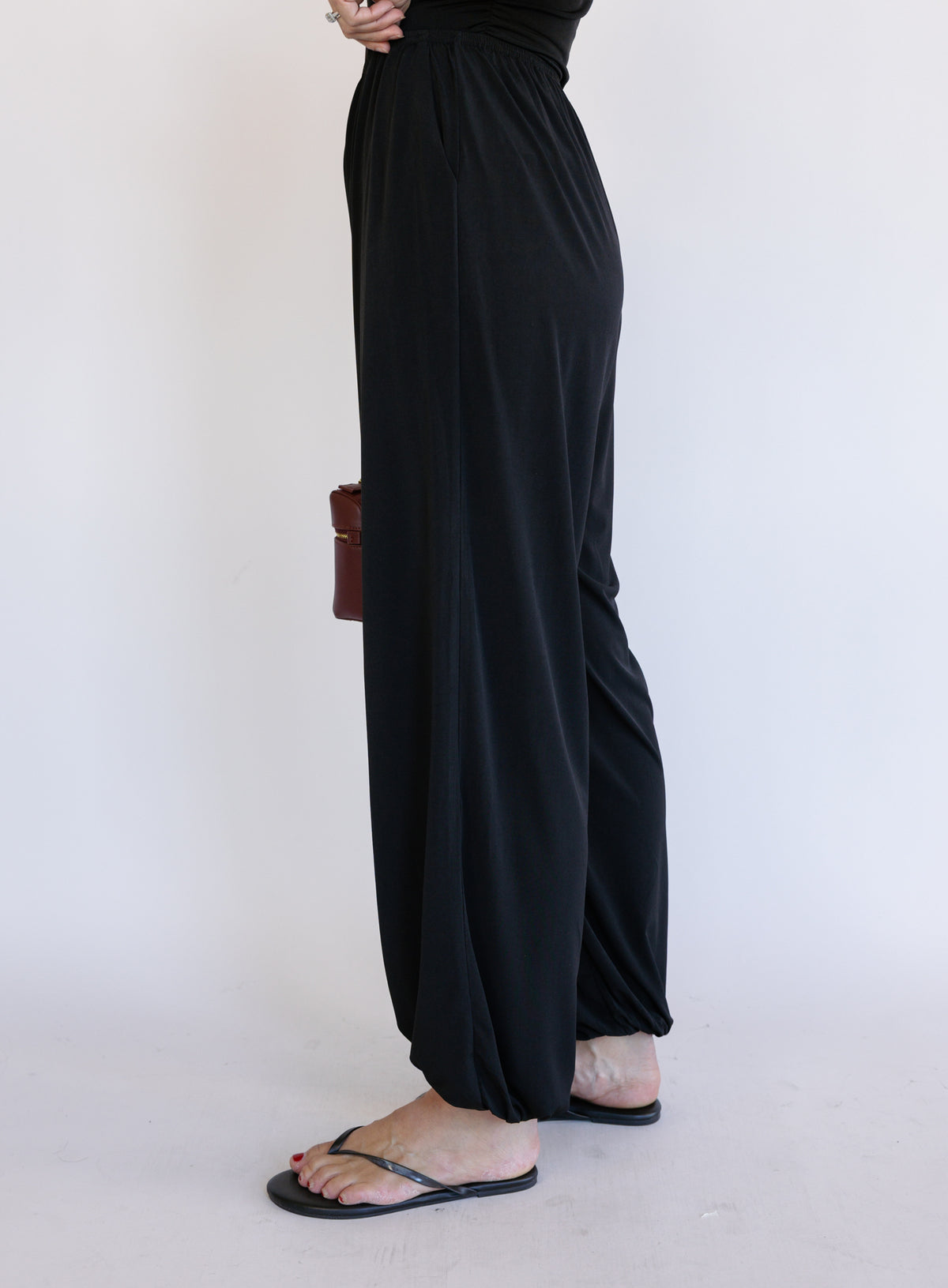 Woman wearing the Azalea Balloon Pants, black lightweight balloon-leg pants with gathered ankle cuffs