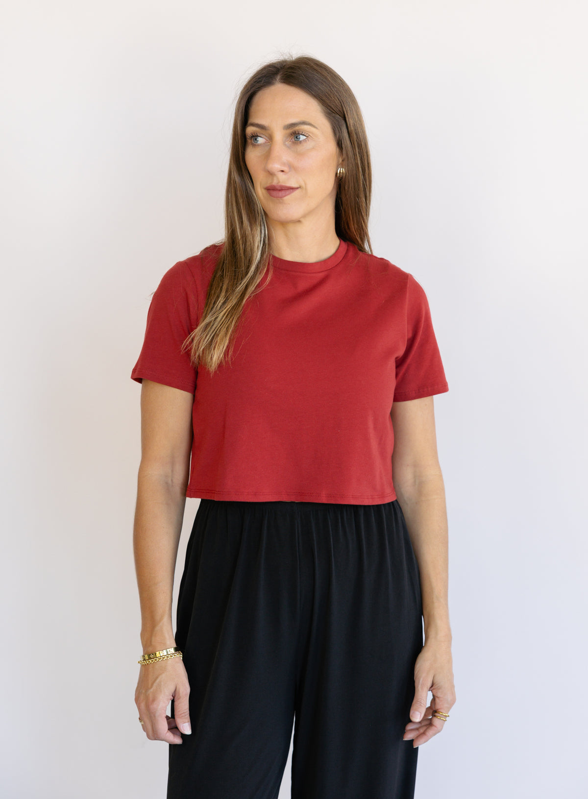 Woman wearing Favorite Daughter The Laura Crop Top in Winery, a fitted cropped crewneck tee