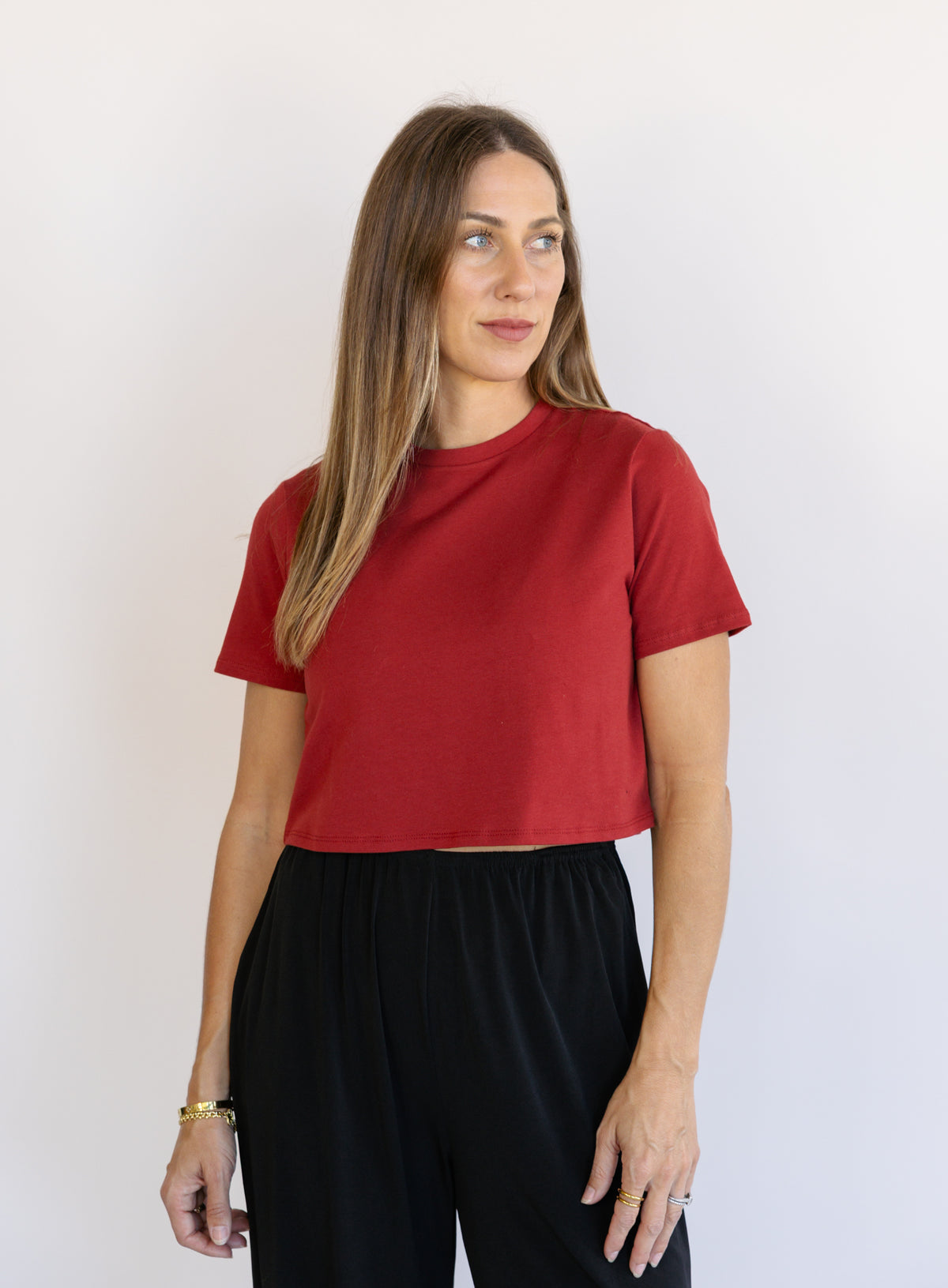 Woman wearing Favorite Daughter The Laura Crop Top in Winery, a fitted cropped crewneck tee