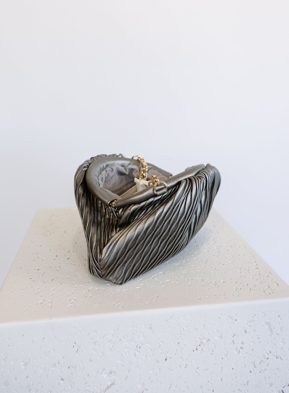 Mallory Clutch, a metallic pewter pleated clutch with a detachable gold chain strap