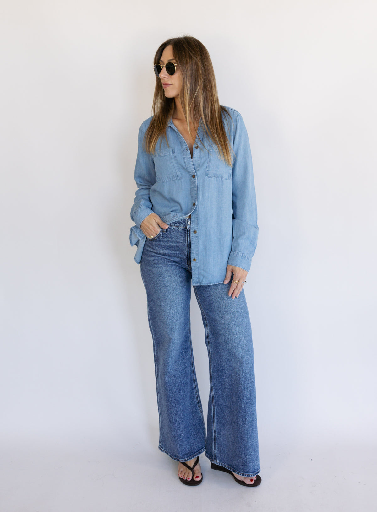 Woman wearing the Ginger Shirt, a light denim wash Tencel button-front chambray shirt