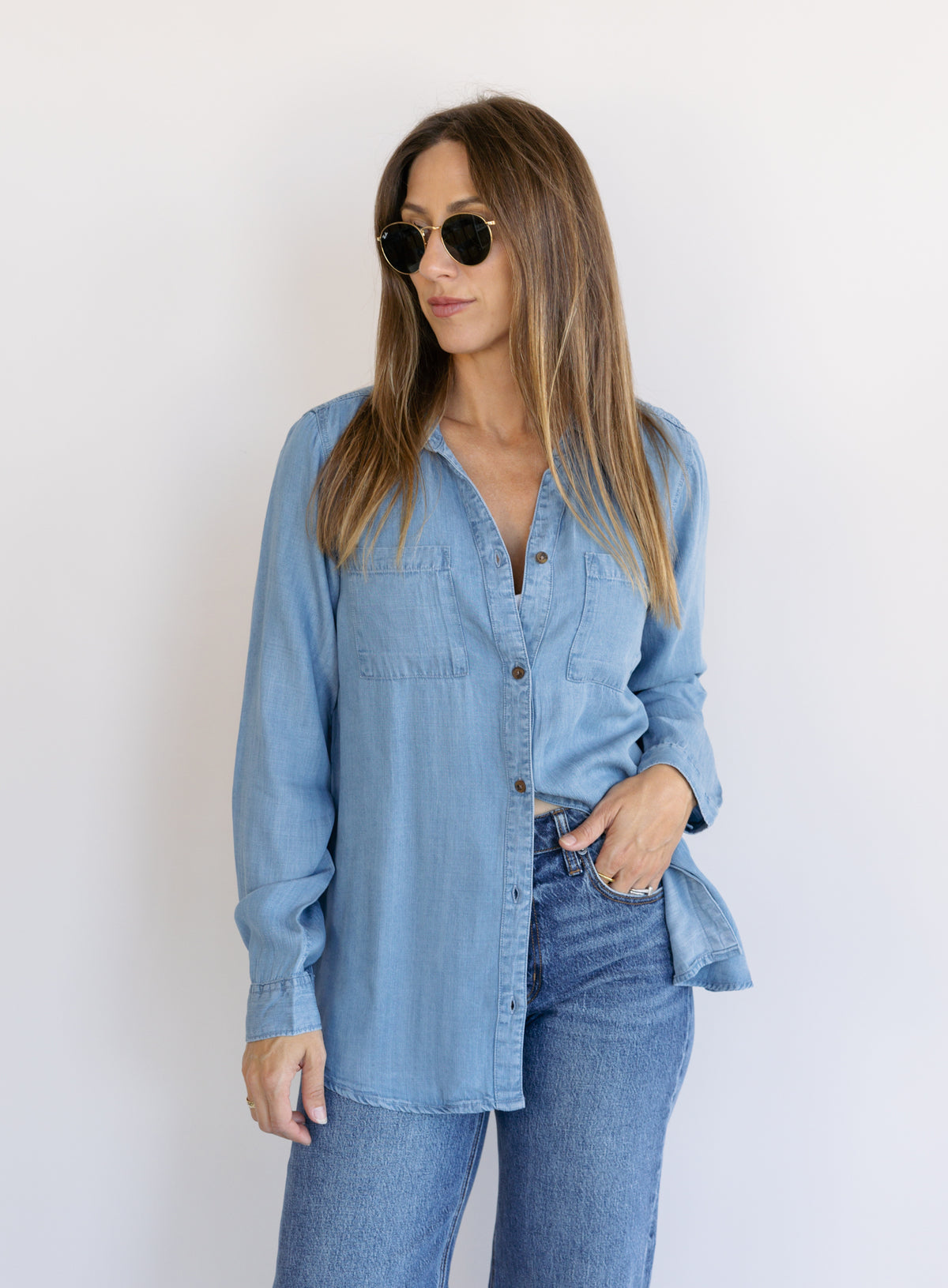 Woman wearing the Ginger Shirt, a light denim wash Tencel button-front chambray shirt