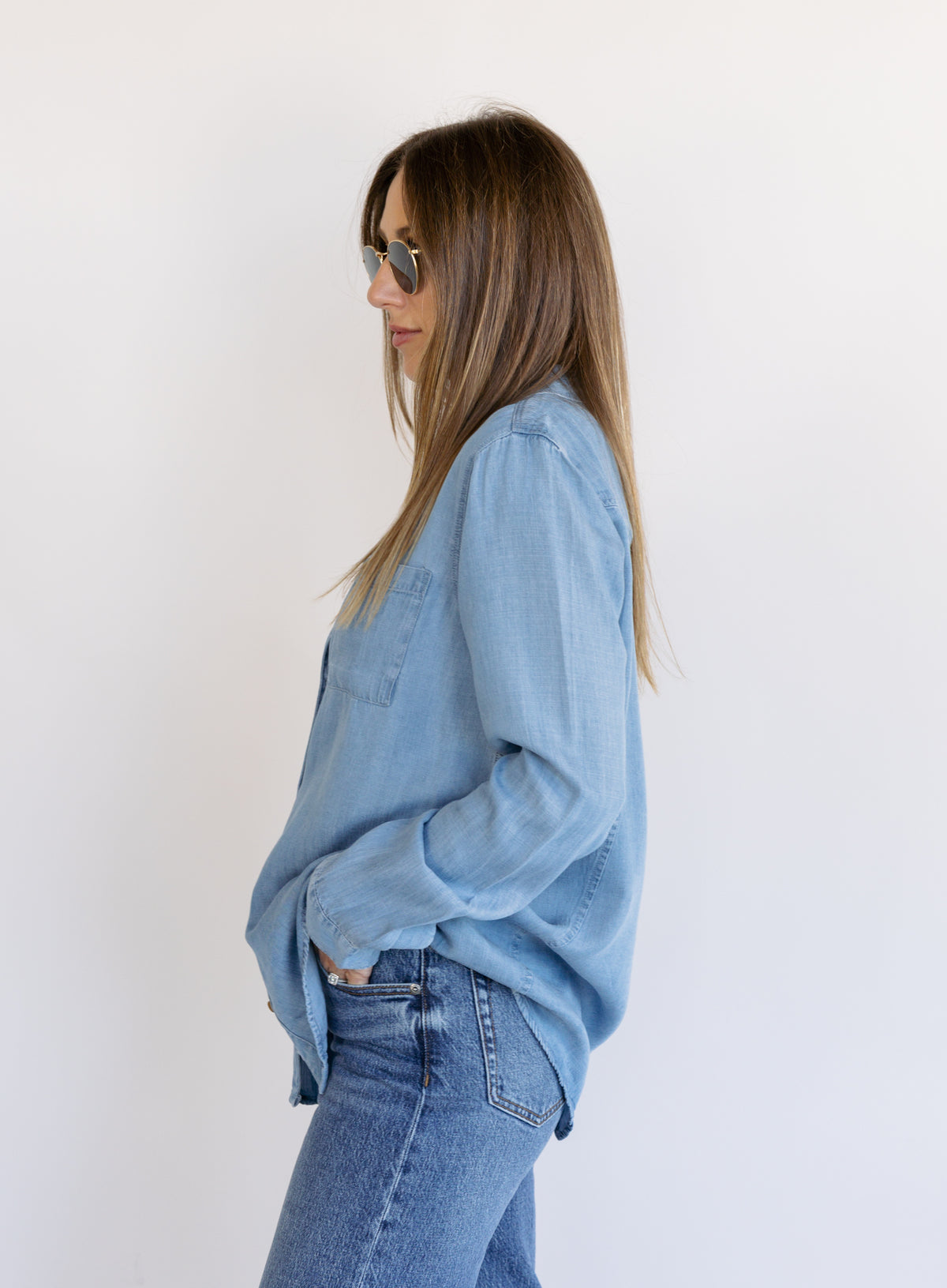 Woman wearing the Ginger Shirt, a light denim wash Tencel button-front chambray shirt