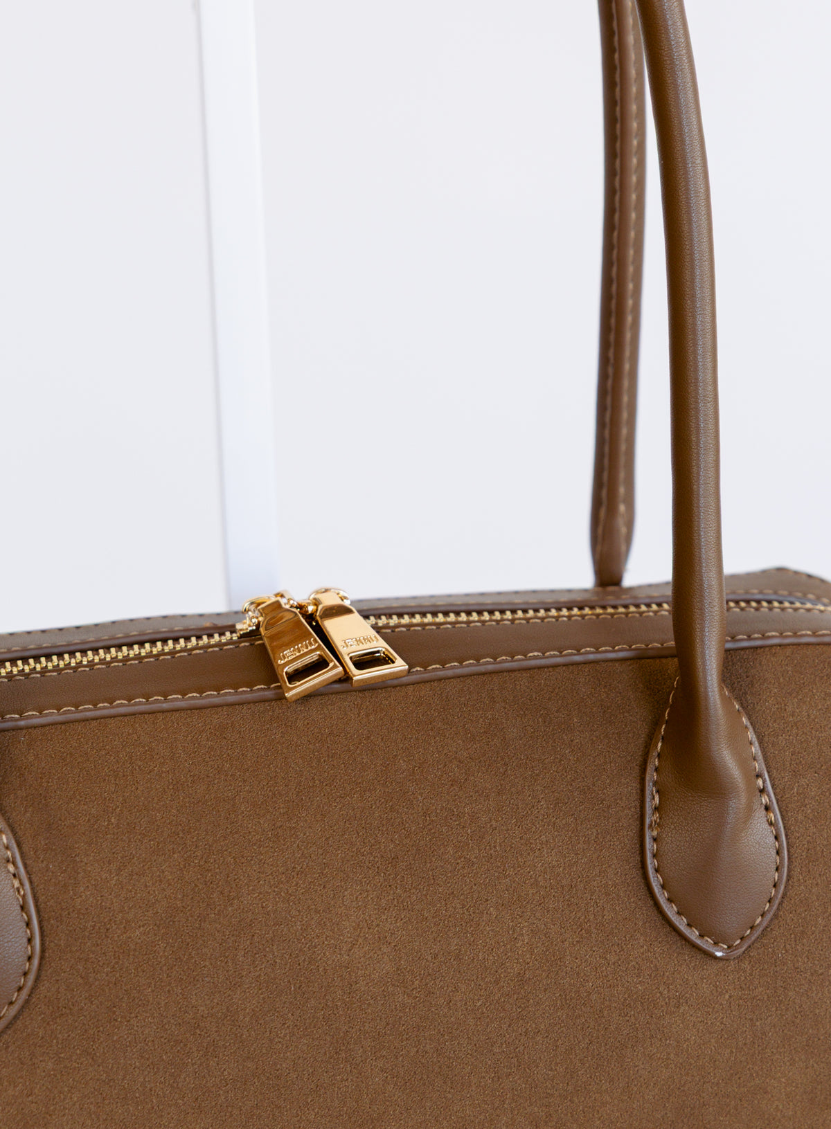 Jonava Suede Bag in Espresso, an elongated suede shoulder bag with gold zipper pulls