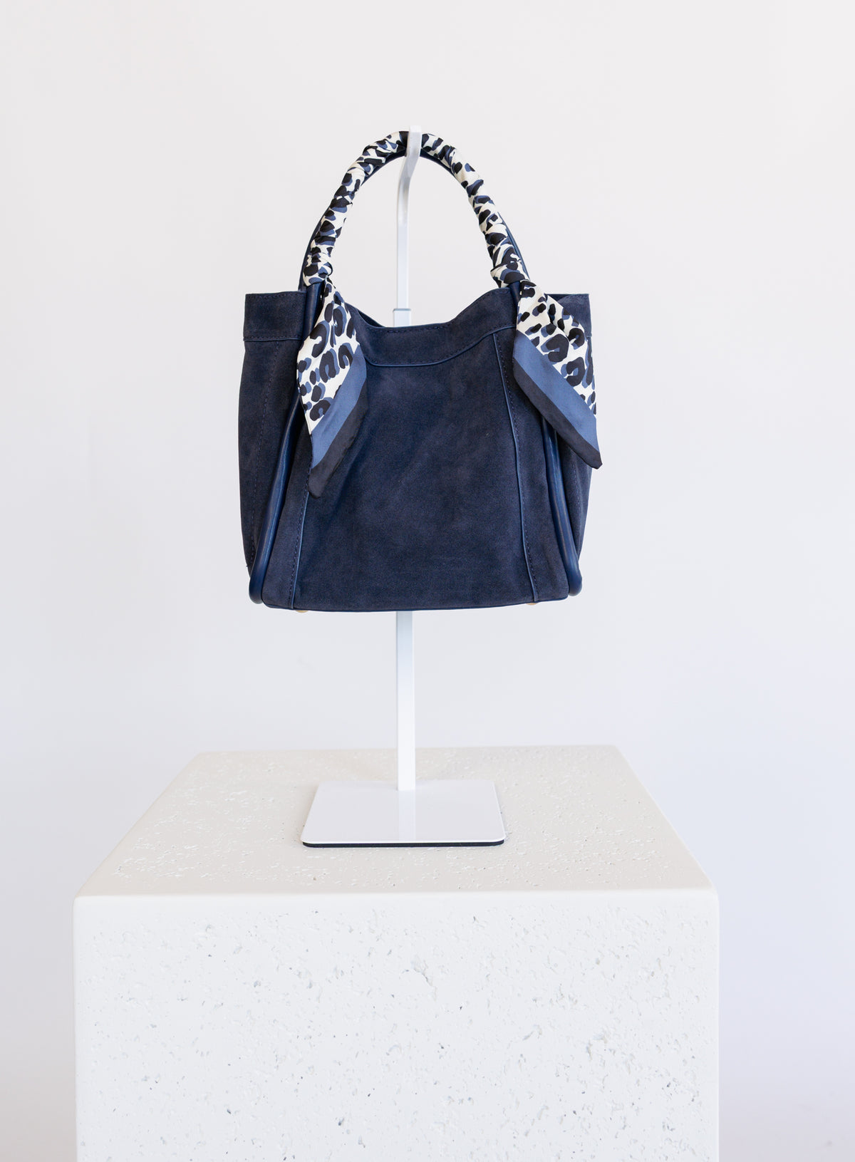 Giselle Suede Bag in Navy, a slouchy suede tote with navy and white leopard scarves on the handles