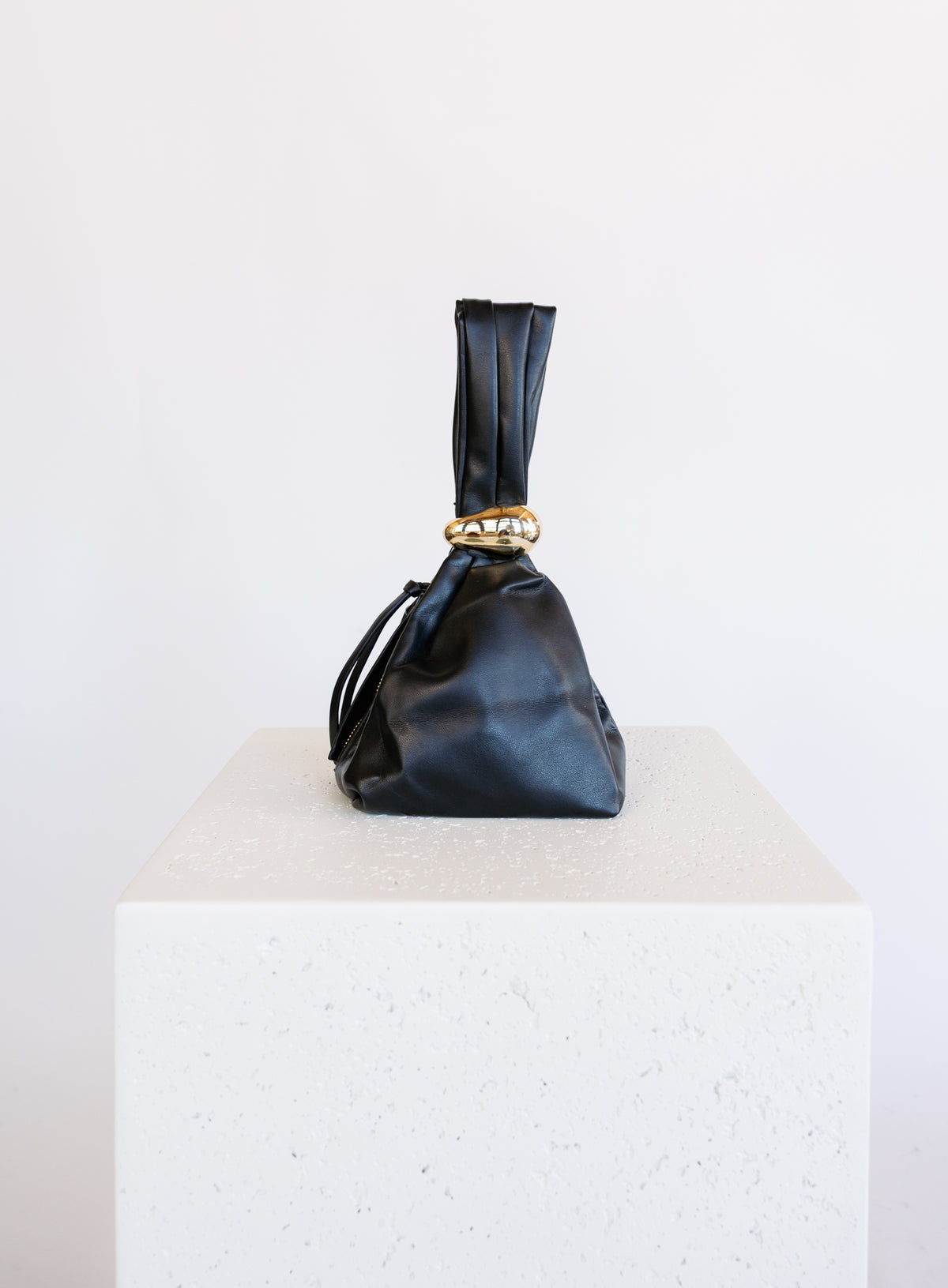 Celine Evening Bag, a slouchy black pouch with a gold cuff handle