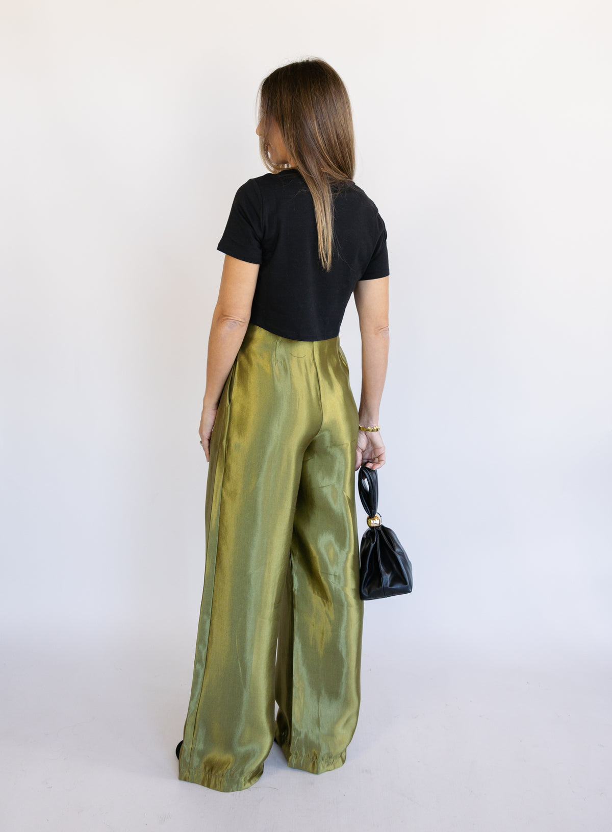 Woman wearing the Sophia Pleated Pants, olive high-rise wide-leg pleated pants
