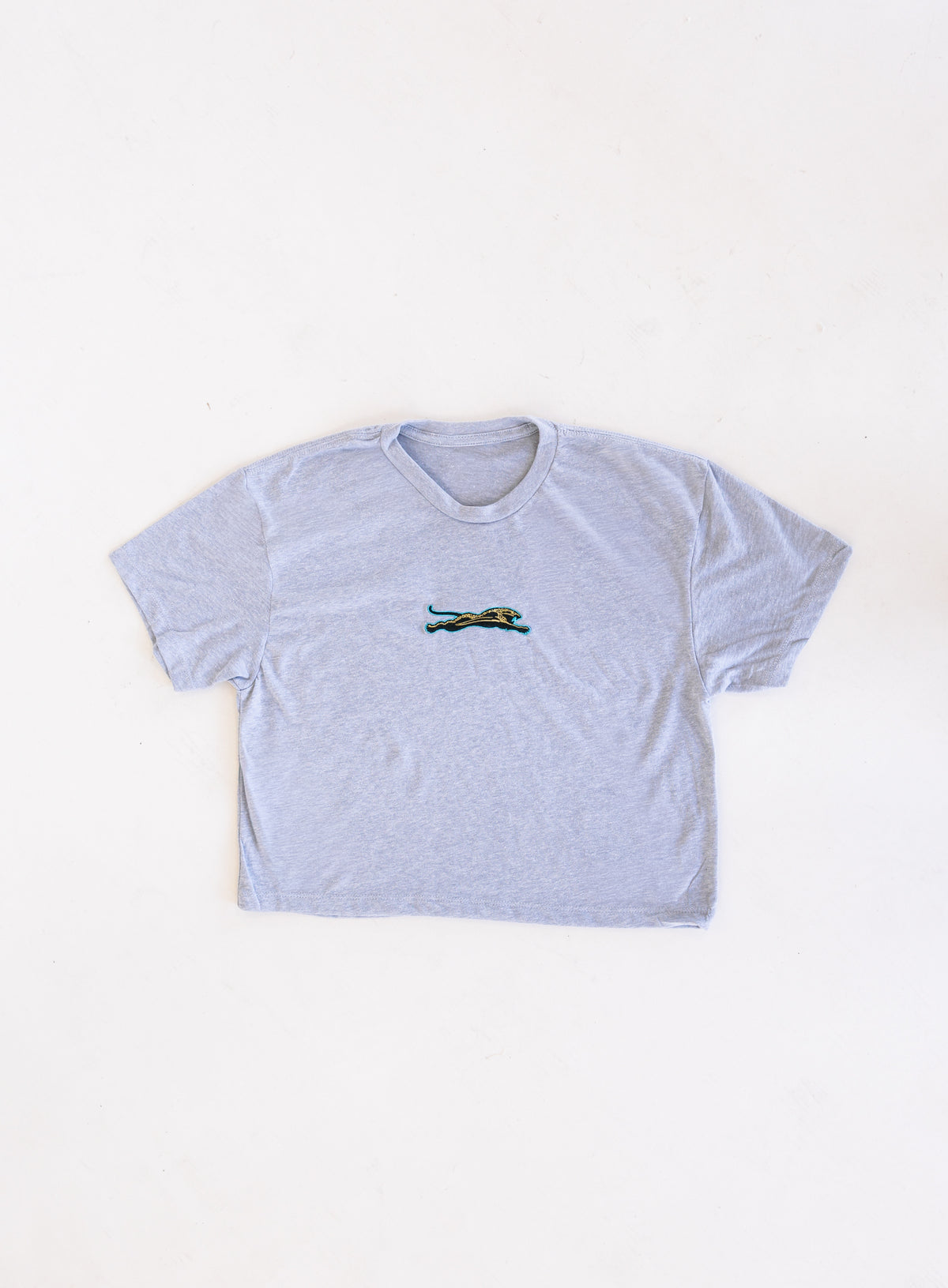 Jags Embroidered Crop Tee, a heather grey crewneck crop tee with a teal and gold embroidered jaguar
