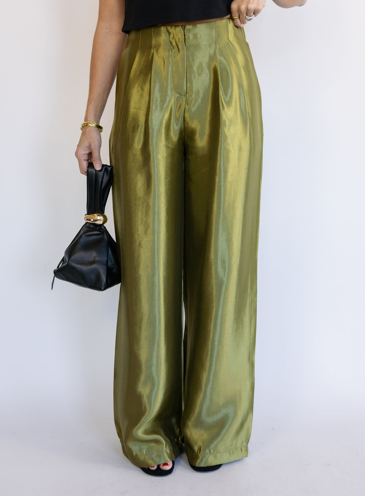 Woman wearing the Sophia Pleated Pants, olive high-rise wide-leg pleated pants