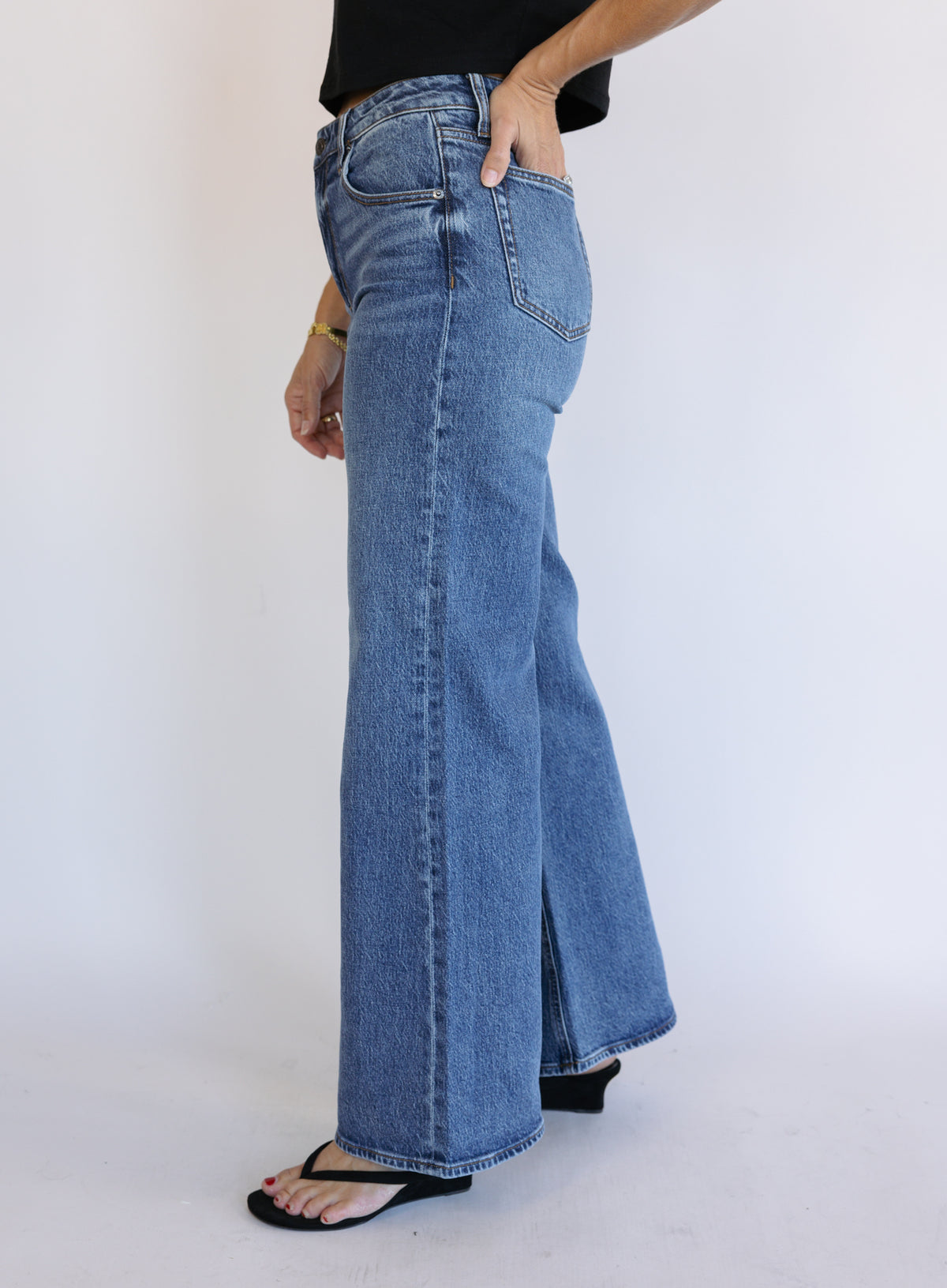 Woman wearing Z Supply The Stunner Mid Rise Wide Leg jeans in Element, a vintage medium wash
