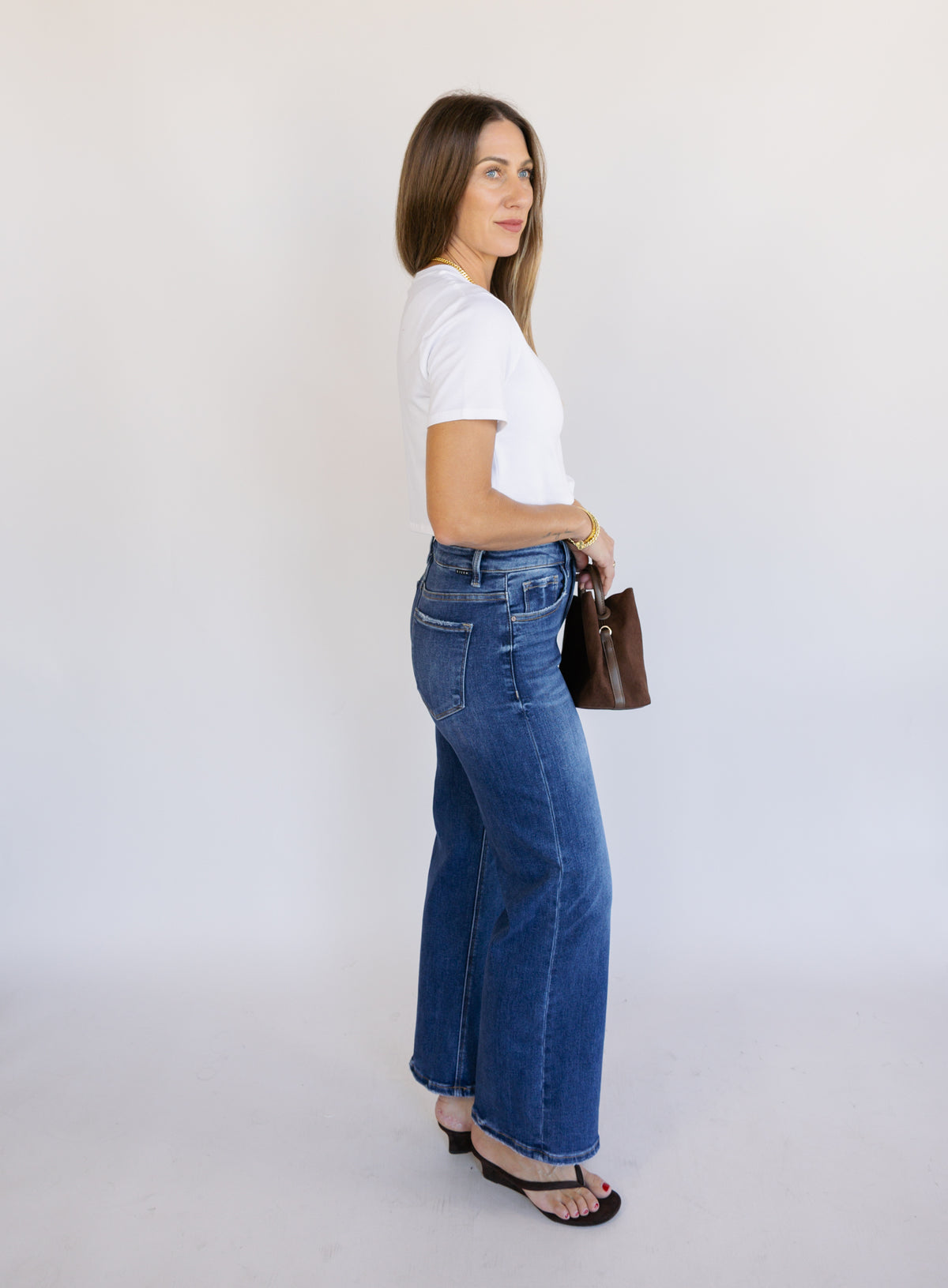 Woman wearing the Jude High Rise Straight Denim, medium blue wash high-rise ankle straight-leg jeans