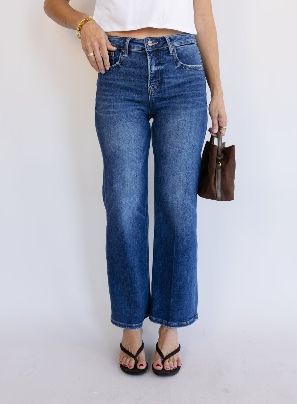 Woman wearing the Jude High Rise Straight Denim, medium blue wash high-rise ankle straight-leg jeans
