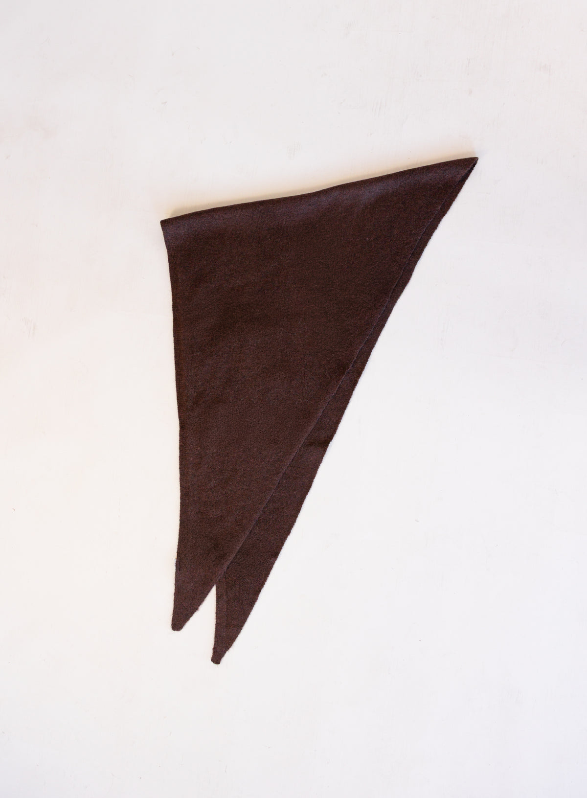 Woman wearing the Wrenley Warm Shawl Scarf in Brown, a chocolate brown knit triangle shawl