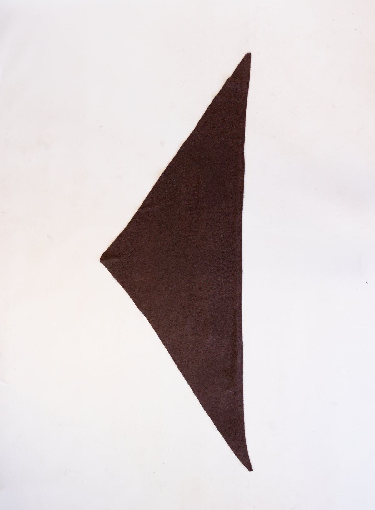 Woman wearing the Wrenley Warm Shawl Scarf in Brown, a chocolate brown knit triangle shawl
