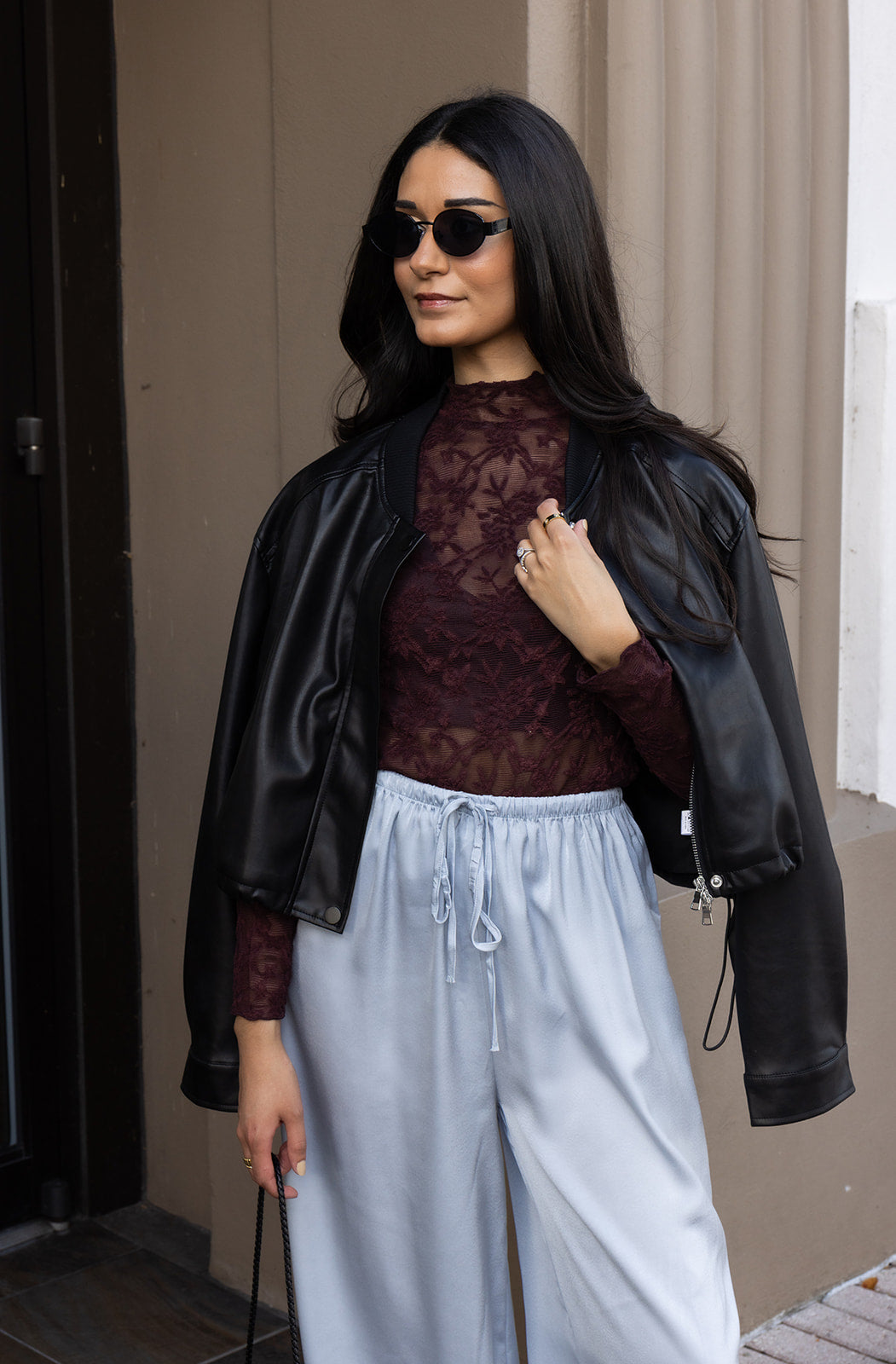 Woman wearing the ASTR The Label Kyra Sheer Mesh Mock Neck Top, a fitted wine top with floral lace detailing