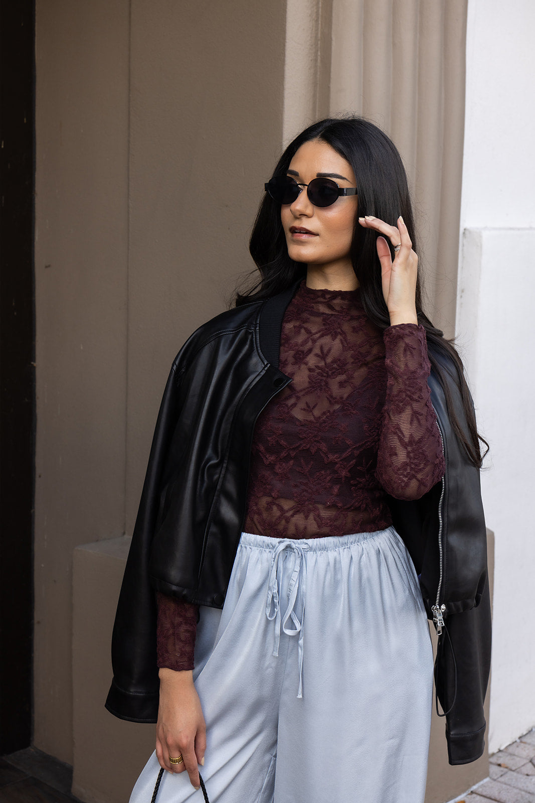 Woman wearing the ASTR The Label Kyra Sheer Mesh Mock Neck Top, a fitted wine top with floral lace detailing