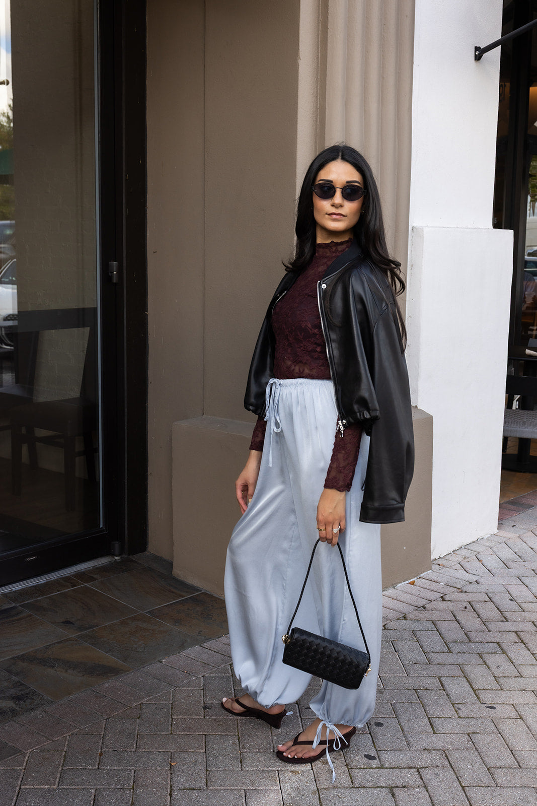 Woman wearing the ASTR The Label Kyra Sheer Mesh Mock Neck Top, a fitted wine top with floral lace detailing