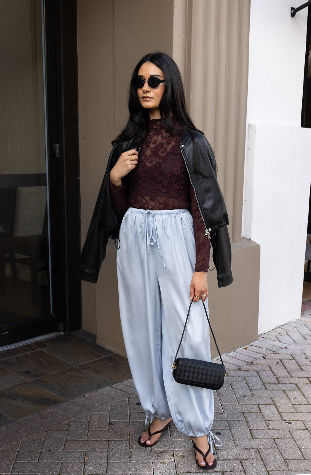 Woman wearing the ASTR The Label Kyra Sheer Mesh Mock Neck Top, a fitted wine top with floral lace detailing