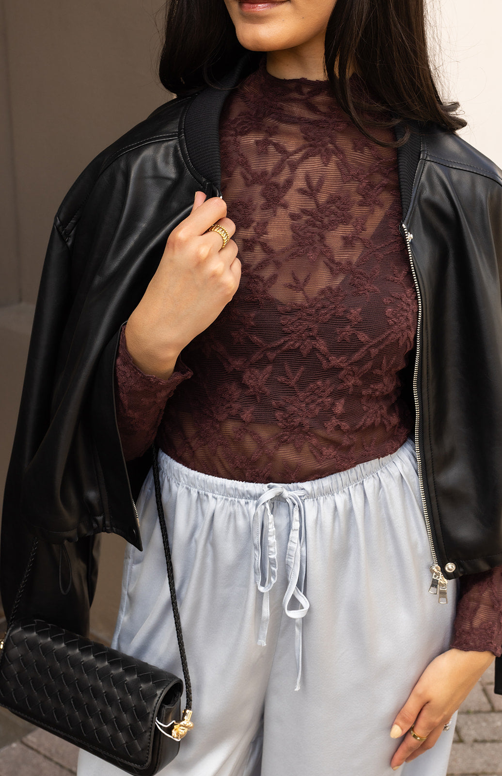 Woman wearing the ASTR The Label Kyra Sheer Mesh Mock Neck Top, a fitted wine top with floral lace detailing