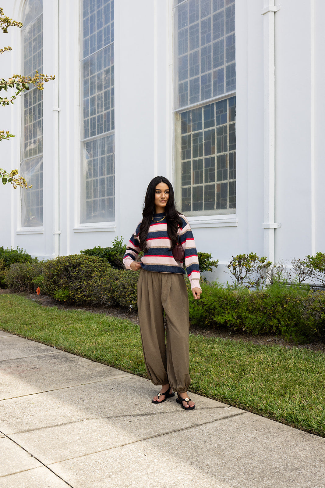 Woman wearing the Carlyle Everyday Sweater, a relaxed navy, cream and blush striped crewneck sweater