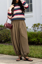 Woman wearing the Carlyle Everyday Sweater, a relaxed navy, cream and blush striped crewneck sweater