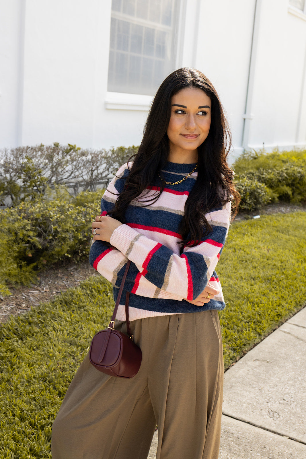 Woman wearing the Carlyle Everyday Sweater, a relaxed navy, cream and blush striped crewneck sweater