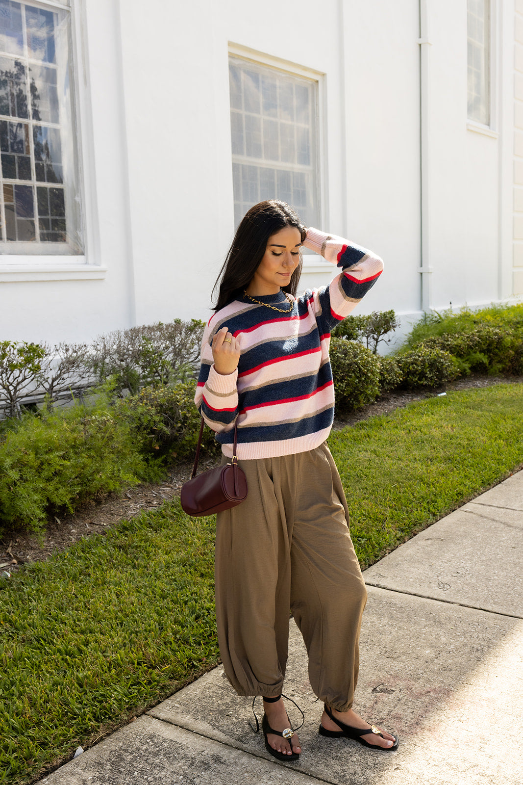 Woman wearing the Carlyle Everyday Sweater, a relaxed navy, cream and blush striped crewneck sweater