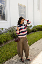 Woman wearing the Carlyle Everyday Sweater, a relaxed navy, cream and blush striped crewneck sweater