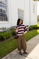 Woman wearing the Carlyle Everyday Sweater, a relaxed navy, cream and blush striped crewneck sweater