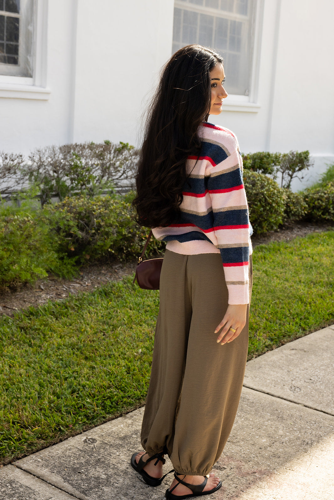 Woman wearing the Carlyle Everyday Sweater, a relaxed navy, cream and blush striped crewneck sweater