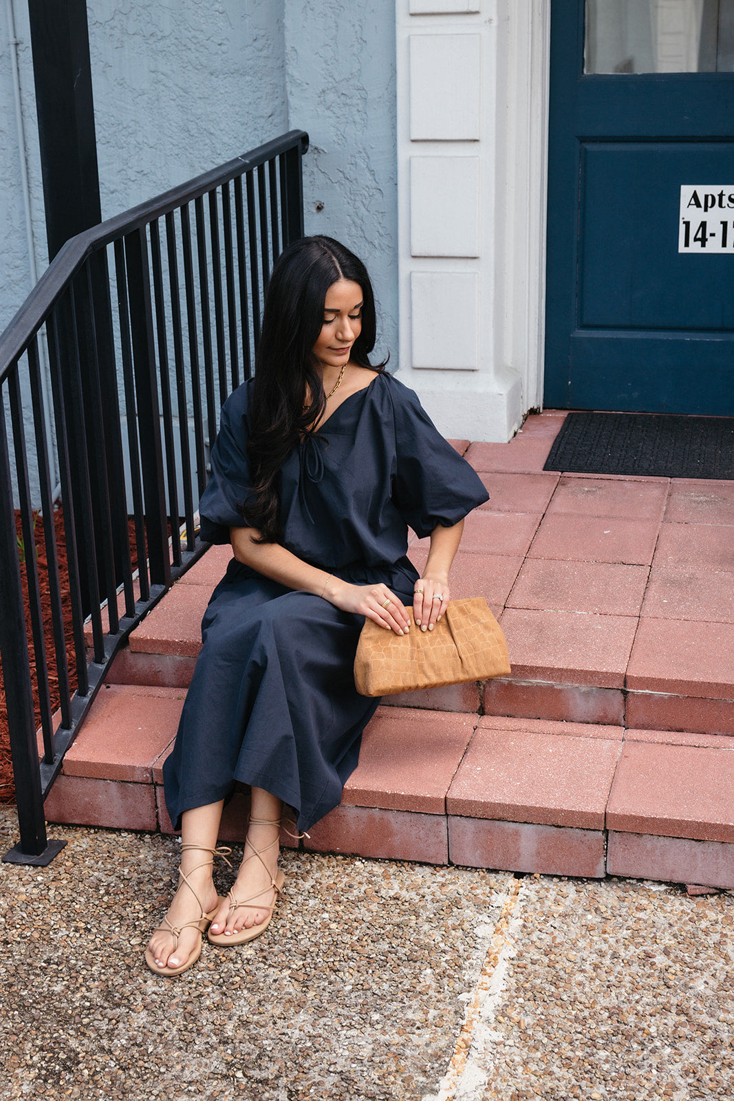 Woman wearing the Cordelia Skirt, a navy maxi skirt with an elastic waist and pockets
