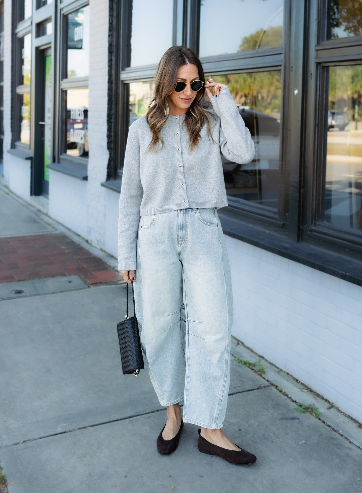 Woman wearing the Cova Cardigan, a grey cropped cotton-wool crewneck cardigan