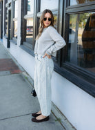 Woman wearing the Cova Cardigan, a grey cropped cotton-wool crewneck cardigan