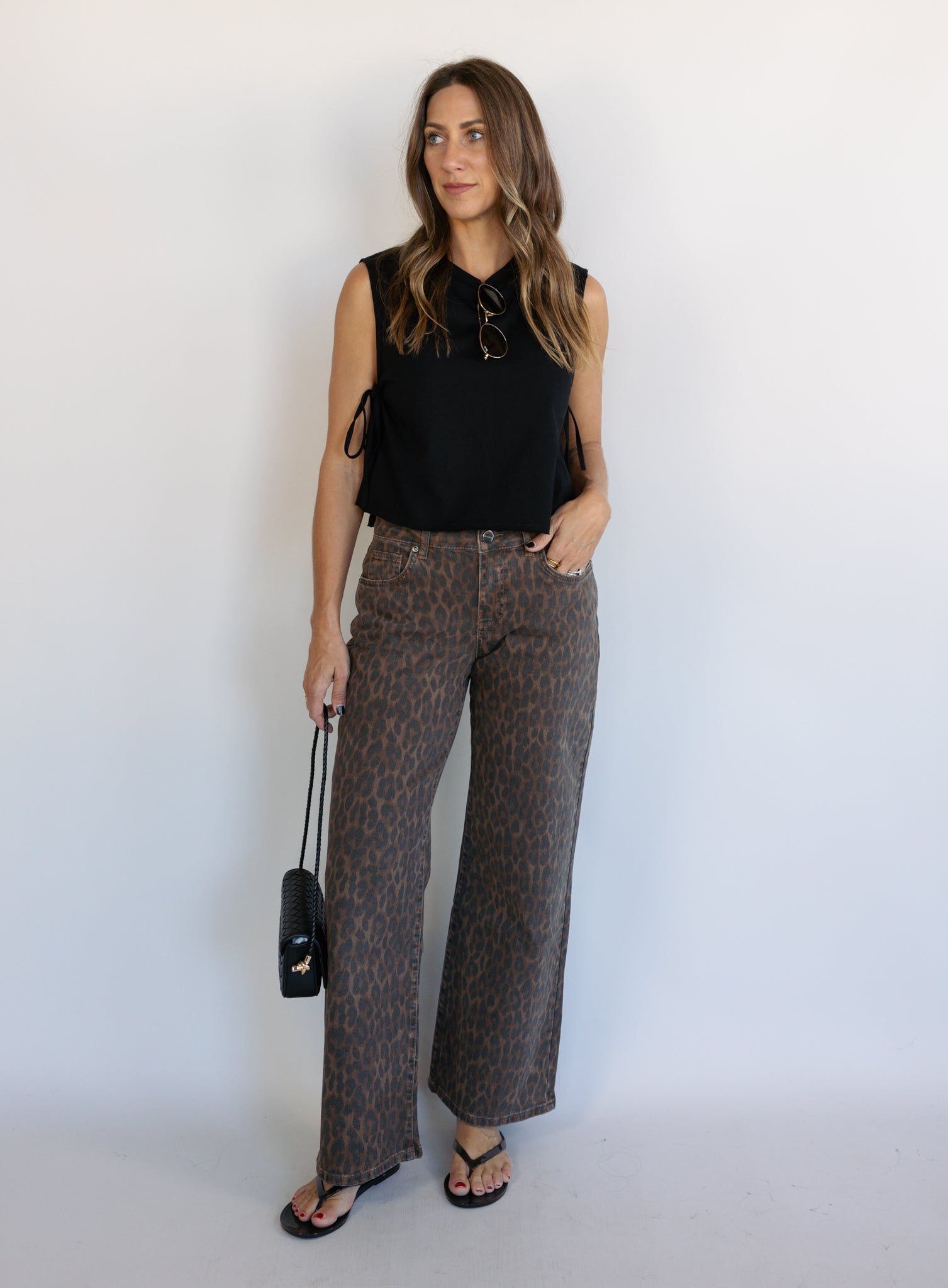 Woman wearing the Colette Wide Leg Jeans in Rebel Cat, brown and charcoal leopard print mid-rise jeans