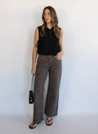 Woman wearing the Colette Wide Leg Jeans in Rebel Cat, brown and charcoal leopard print mid-rise jeans