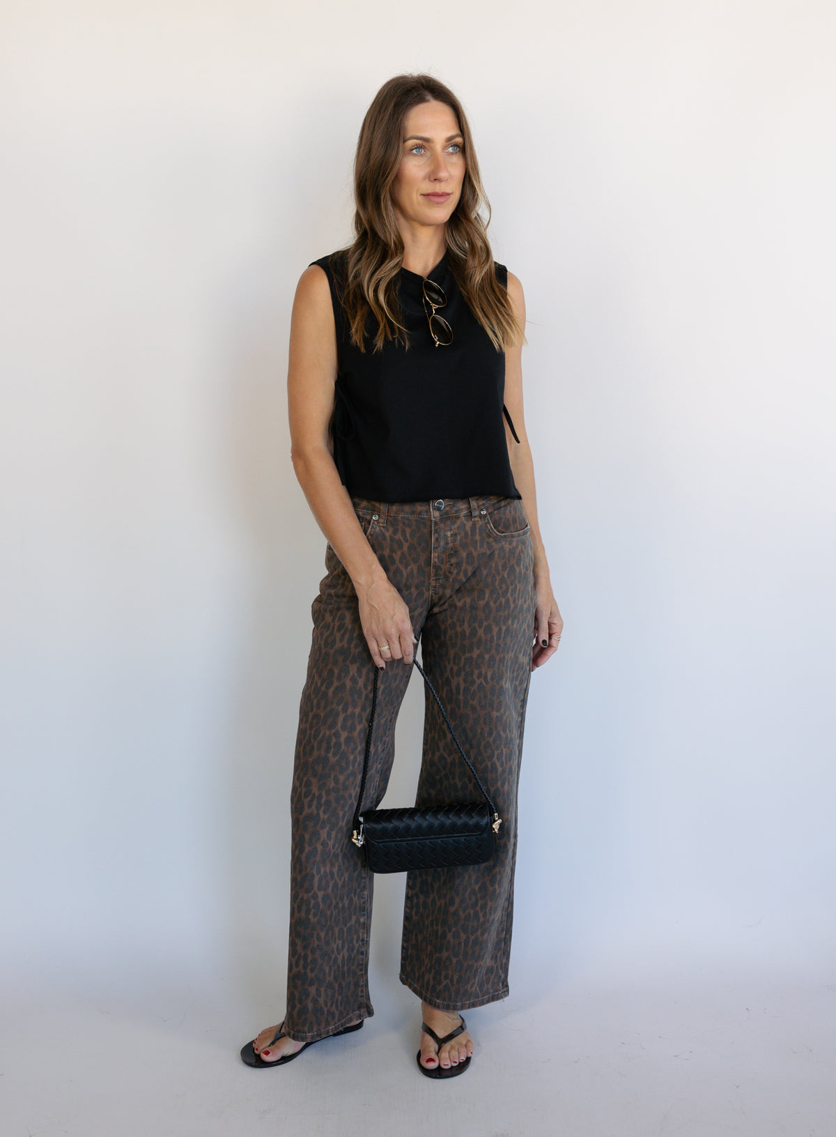 Woman wearing the Colette Wide Leg Jeans in Rebel Cat, brown and charcoal leopard print mid-rise jeans