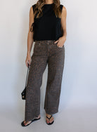 Woman wearing the Dayton Crop Top, a black boxy sleeveless crop top with side ties