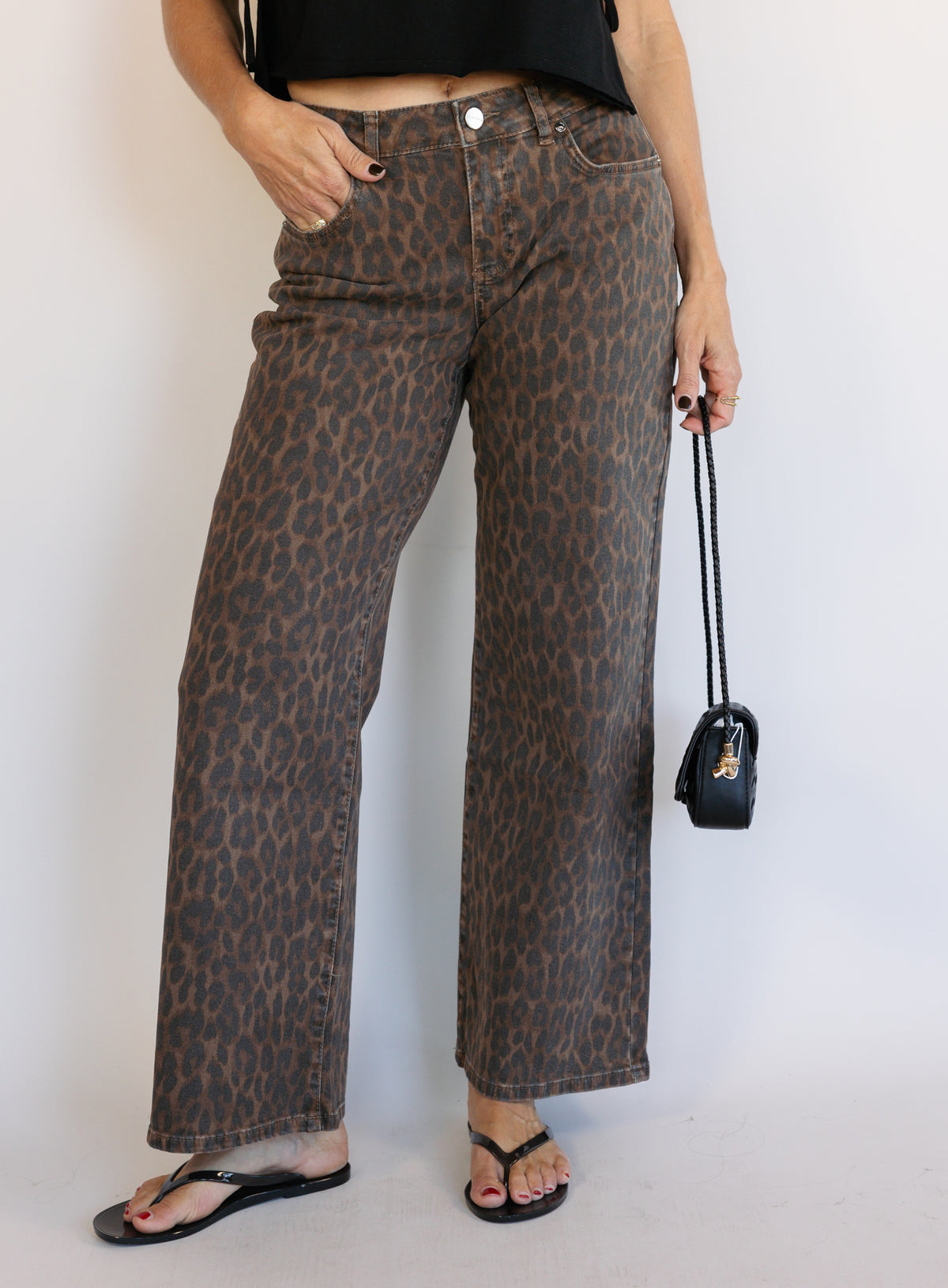 Woman wearing the Colette Wide Leg Jeans in Rebel Cat, brown and charcoal leopard print mid-rise jeans