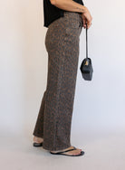 Woman wearing the Colette Wide Leg Jeans in Rebel Cat, brown and charcoal leopard print mid-rise jeans